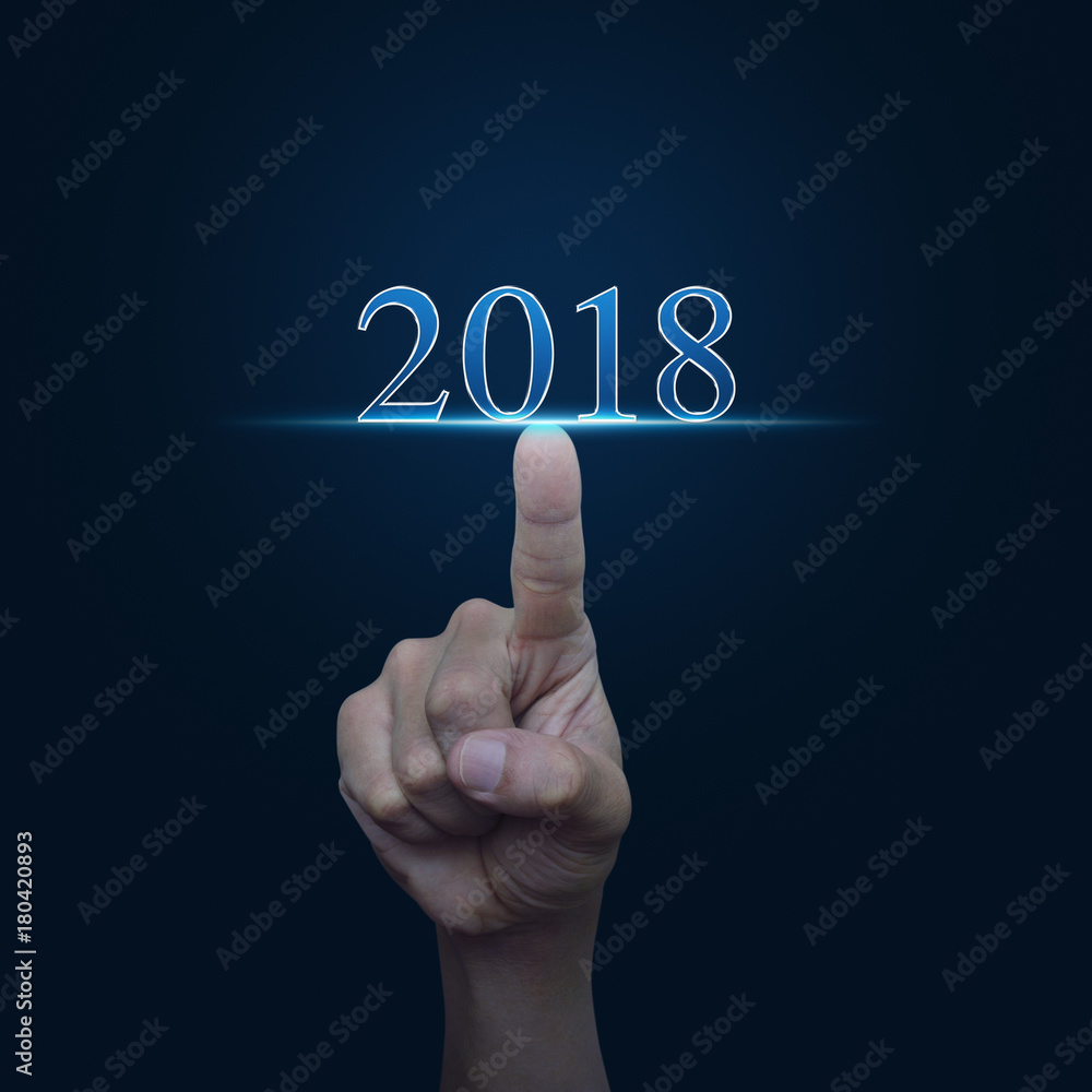Hand pressing 2018 text over gradient blue background, Happy new year concept Hand pressing 2018 text over gradient blue background, Happy new year concept