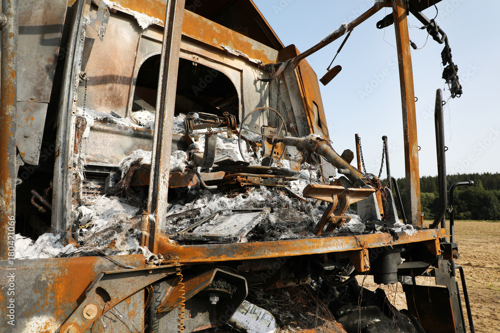 Fototapeta premium Combine harvester destroyed by fire