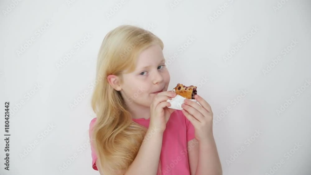 blonde girl eats cherry pie on white background close-up