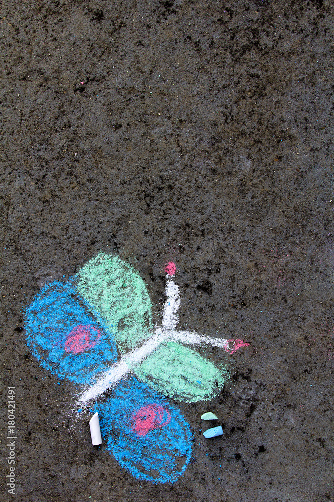 Obraz premium Colorful chalk drawing on asphalt: beautiful butterfly