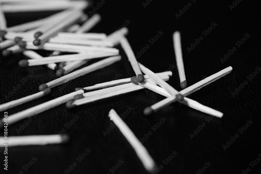 Scattered matches on dark background close up. Black and white Scattered matches on dark background close up. Black and white