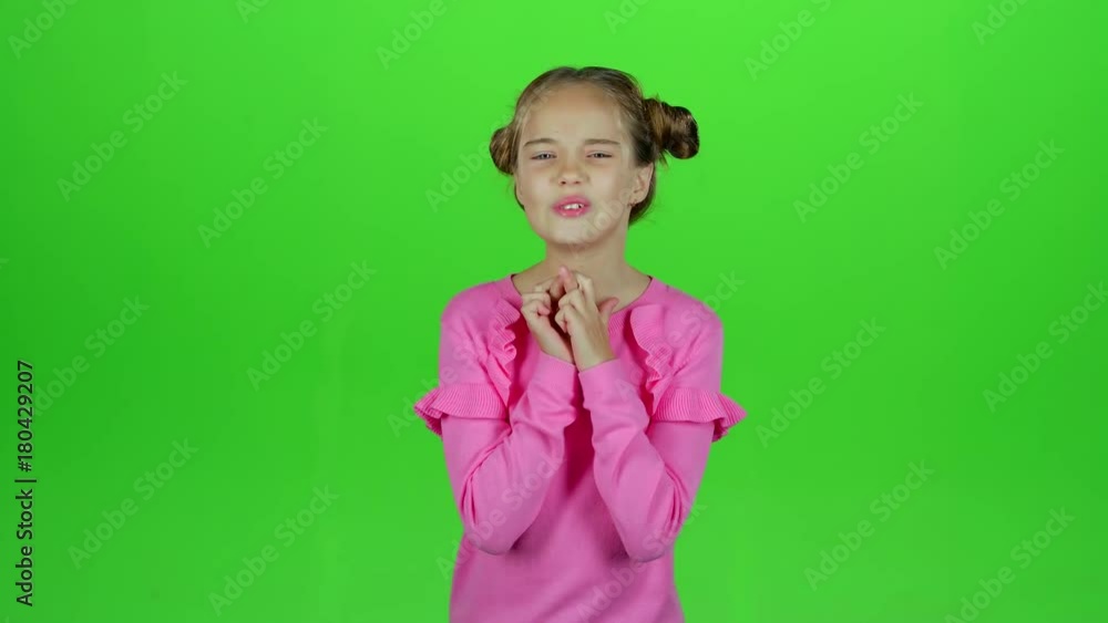 Child crosses his fingers, she hopes to win. Green screen. Slow motion Child crosses his fingers, she hopes to win. Green screen. Slow motion