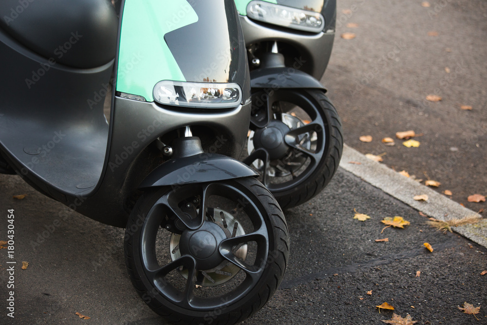 Electric scooter on a city street. Car sharing Electric scooter on a city street. Car sharing