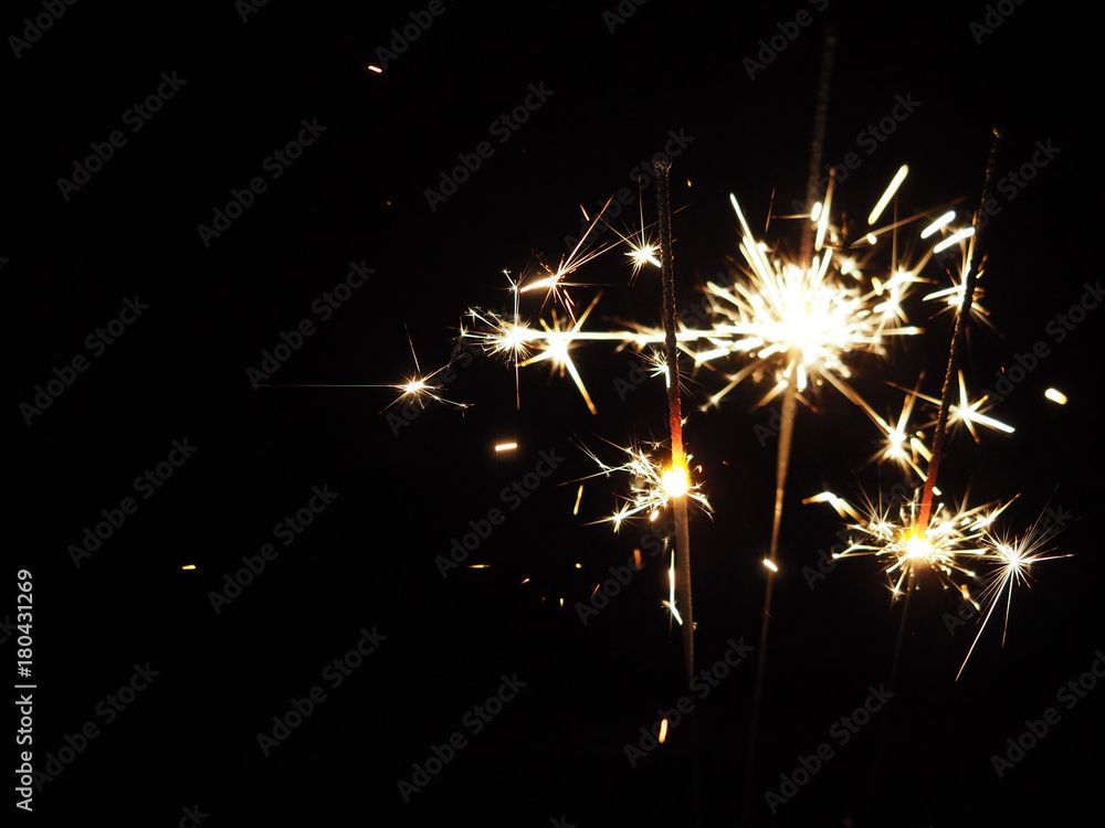 Obraz premium Christmas sparklers in the dark, background for xmas, new year