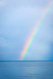 Rainbow over the blue water