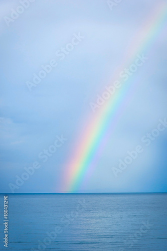 Rainbow over the blue water