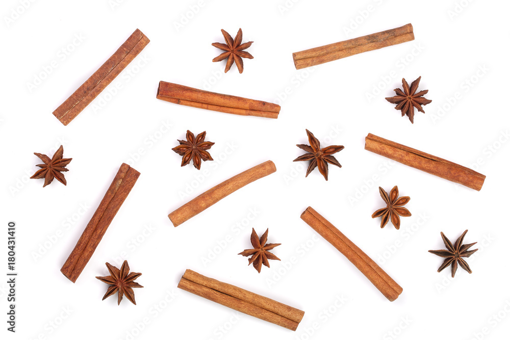 Composition of star anise and cinnamon sticks isolated on white. Abstract pattern flat lay, top view Composition of star anise and cinnamon sticks isolated on white. Abstract pattern flat lay, top view