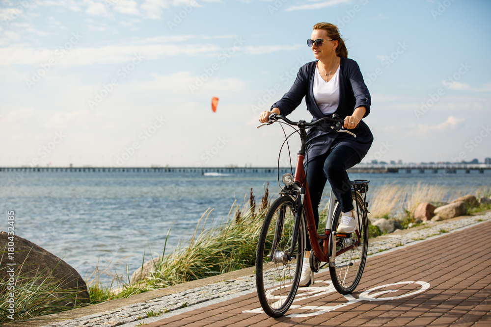 Healthy lifestyle - middle-aged woman riding bicycles Healthy lifestyle - middle-aged woman riding bicycles