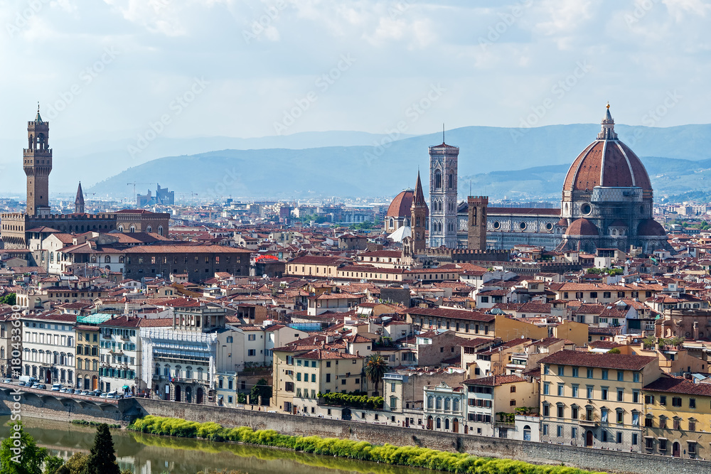 Panoramic view of Florence major monuments - Florence, Tuscany, Italy. You can see Duomo Cathedral, Campanile of Giotto and Palazzo Vecchio surrounded by the typical red roofs of the town