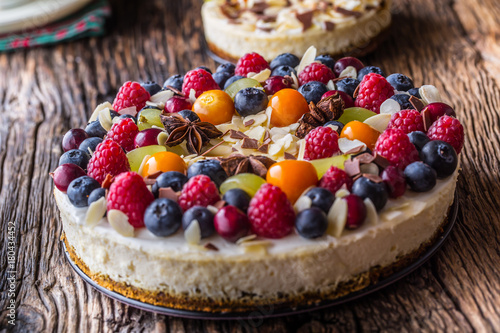 Cheesecake with fresh fruit berries strawberries raspberries and star anise. Christmas cheesecake with christmas decoration photo