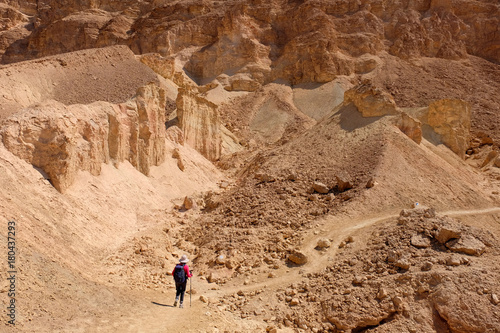 One unrecognized hiker on desert path in Negev mountains.