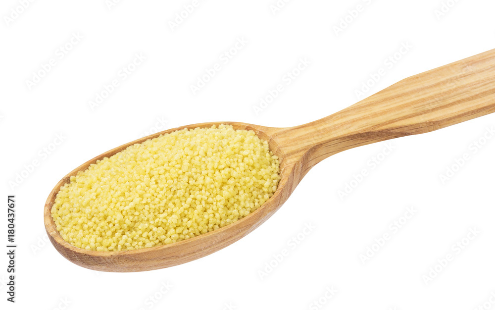 Dry couscous in wooden spoon isolated on white background Dry couscous in wooden spoon isolated on white background