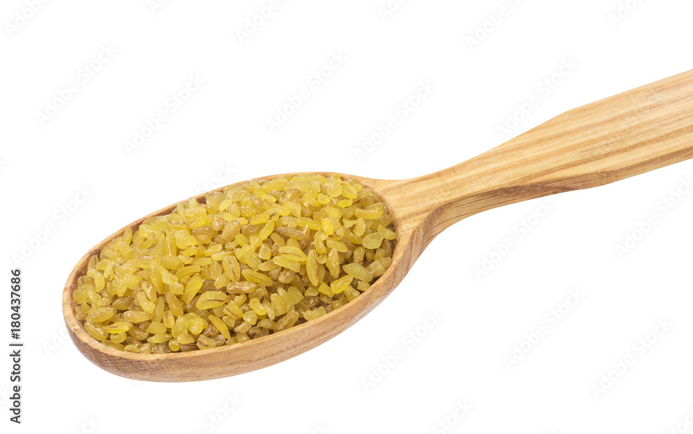 Dry bulgur wheat in wooden spoon isolated on white background Dry bulgur wheat in wooden spoon isolated on white background