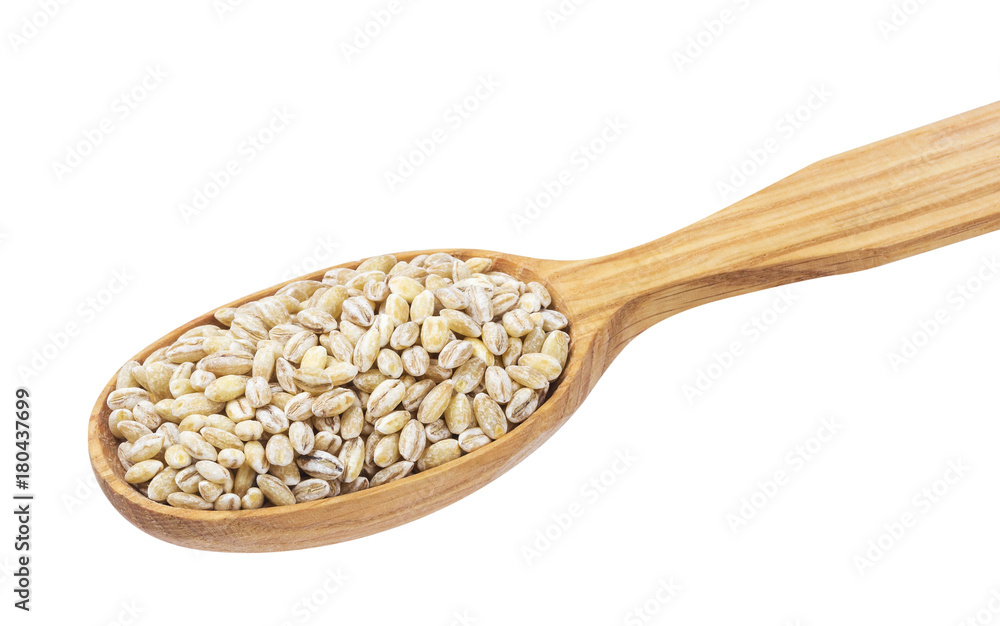 Pearl barley groats in wooden spoon isolated on white background Pearl barley groats in wooden spoon isolated on white background