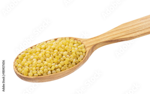 Israeli couscous. Ptitim in wooden spoon isolated on white background