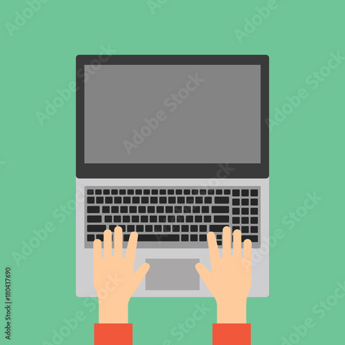 Hands typing on laptop keyboard.