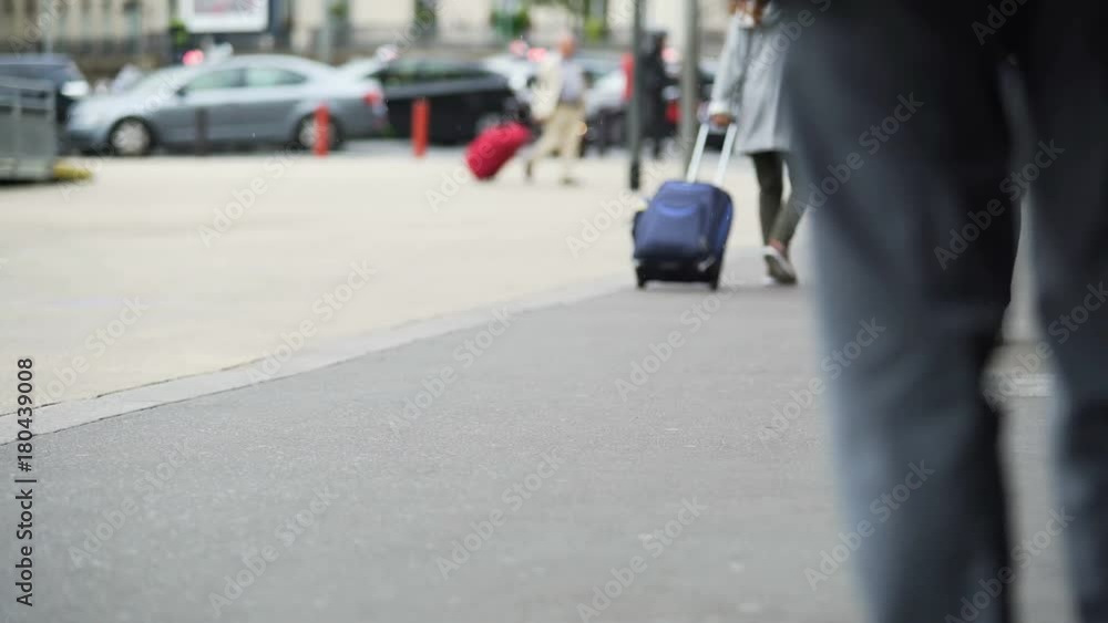 Many people walking near airport and rolling suitcases on caster wheels, travel Many people walking near airport and rolling suitcases on caster wheels, travel