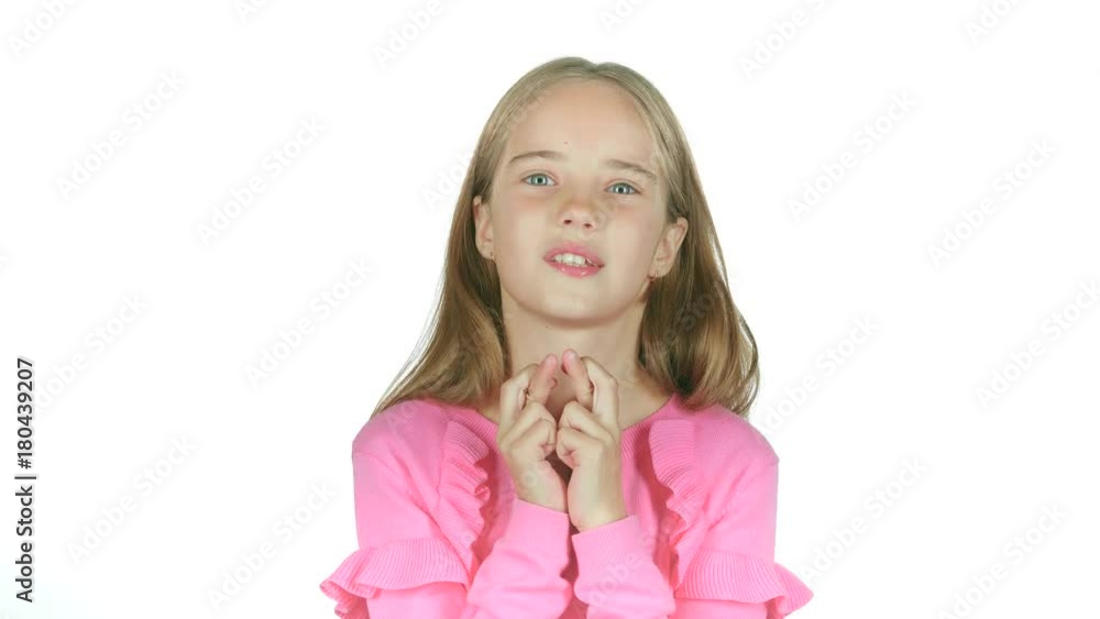 Child crosses his fingers, she hopes to win. White background. Slow motion Child crosses his fingers, she hopes to win. White background. Slow motion
