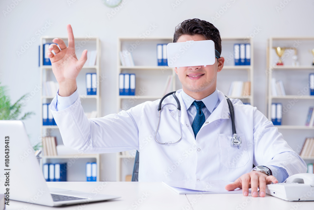 Young doctor with vr virtual reality headset working in the offi Young doctor with vr virtual reality headset working in the offi