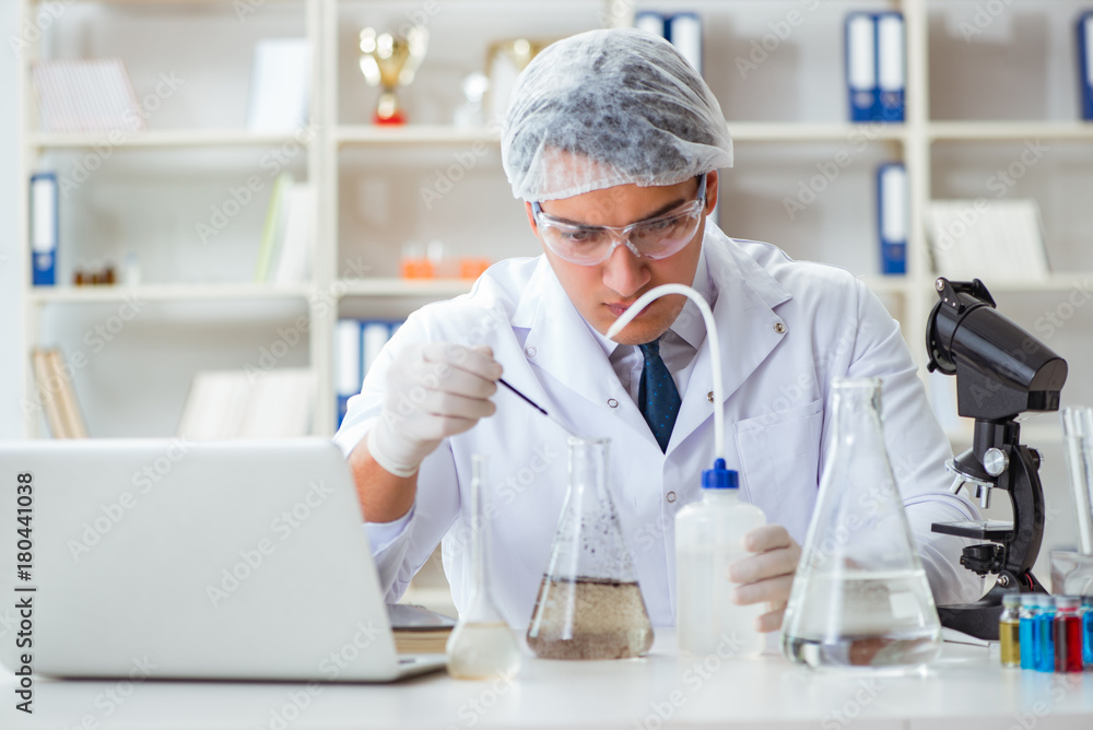 Young researcher scientist doing a water test contamination expe Young researcher scientist doing a water test contamination expe