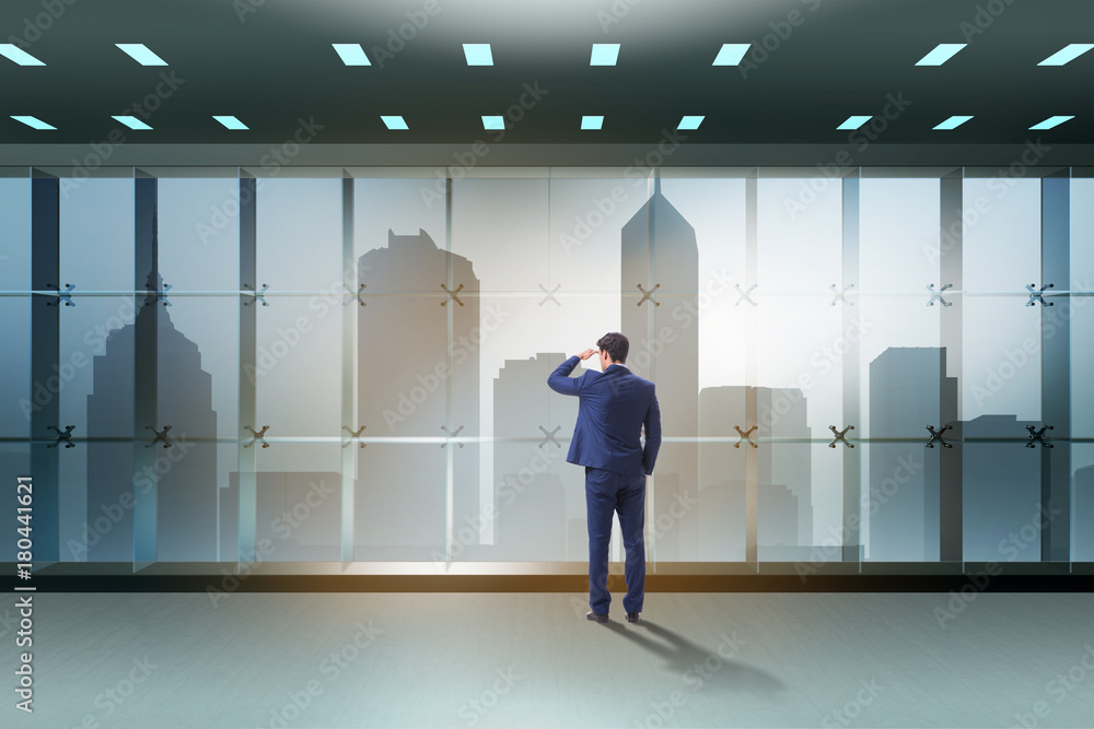 Fototapeta premium Businessman in front of office window thinking of new challenges