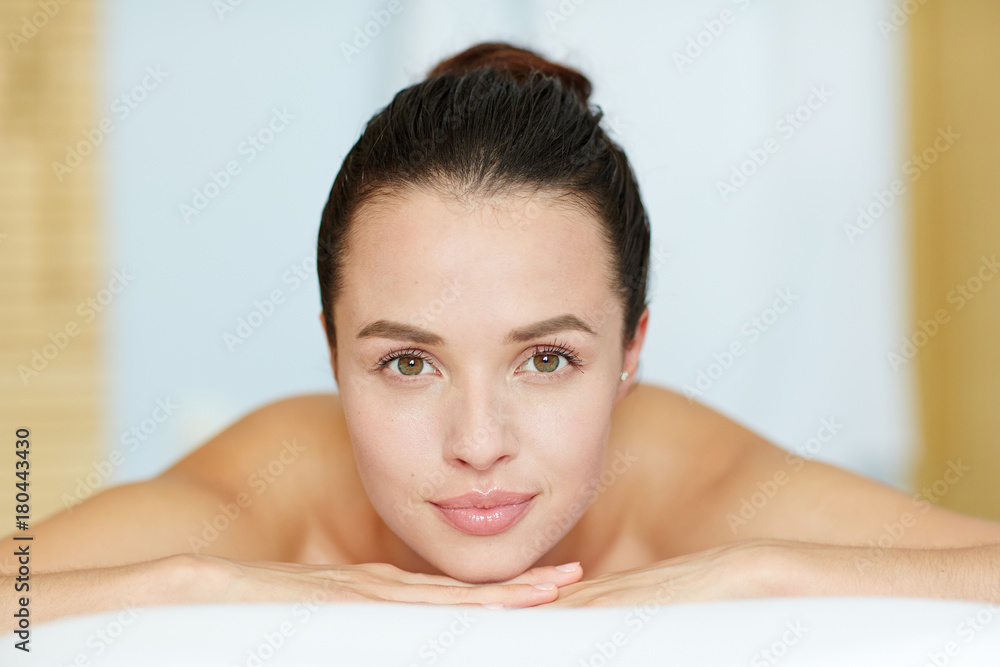Perfect girl with natural makeup looking at camera in spa salon Perfect girl with natural makeup looking at camera in spa salon