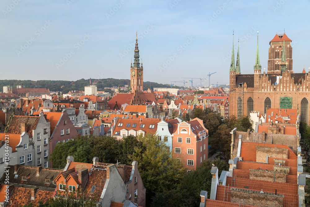 Old residential buildings, Main Town Hall's tower and St. Mary's Church at the Main Town (Old Town) in Gdansk, Poland, viewed from above in the morning.