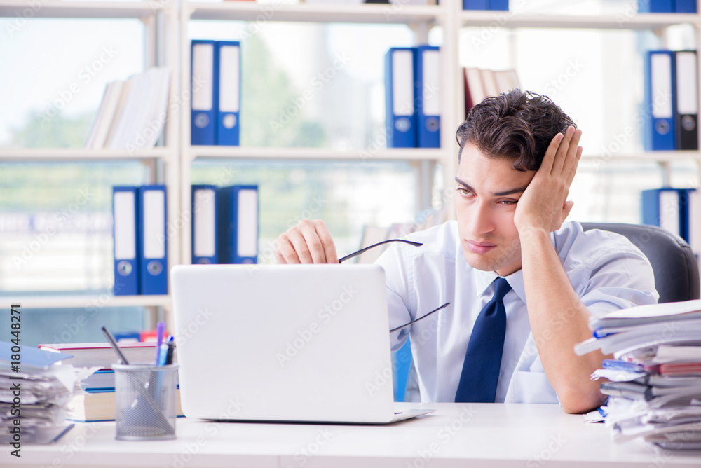Tired exhausted businessman sitting in the office Tired exhausted businessman sitting in the office