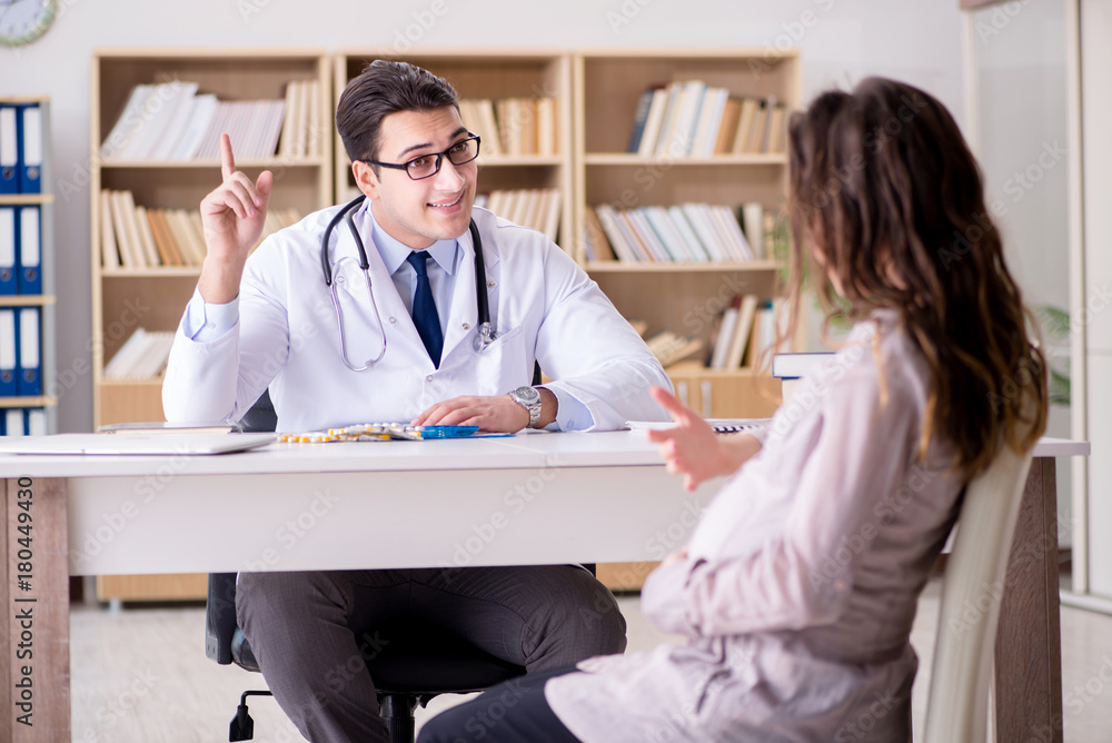 Fototapeta premium Pregnant woman visiting doctor for consultation