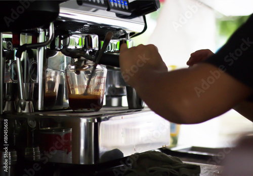 Barista is doing the job with a powerful machine.