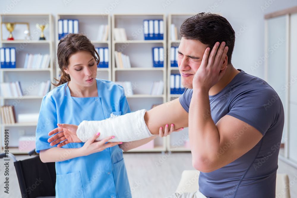 Doctor and patient during check-up for injury in hospital Doctor and patient during check-up for injury in hospital