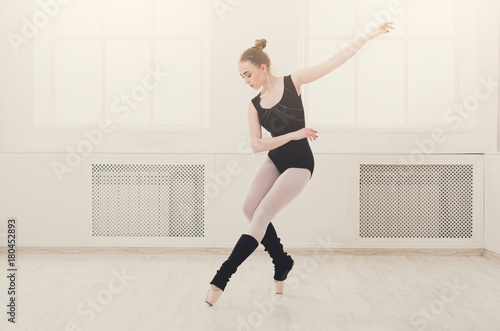 Beautiful ballerina stands in ballet assemble