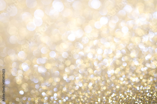 Gold Abstract Christmas twinkled bright background with bokeh defocused lights . Lights Festive background concept.