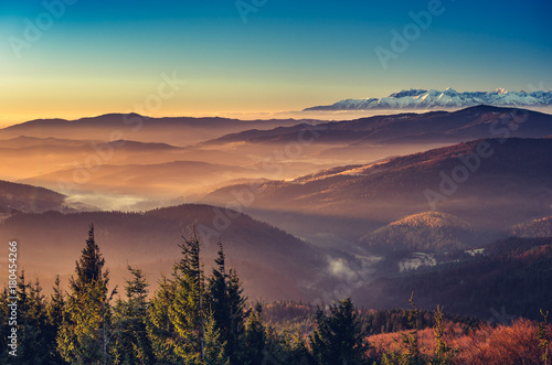 Fototapeta Naklejka Na Ścianę i Meble -  panorama over misty Gorce to snowy Tatra mountains in the morning, Poland landscape