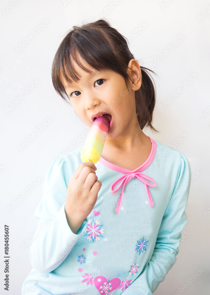 Little girl eating ice cream, ice pop. Favorite dessert for summer time. Fresh and cold. Portrait on white background. Asian children. Little girl eating ice cream, ice pop. Favorite dessert for summer time. Fresh and cold. Portrait on white background. Asian children.
