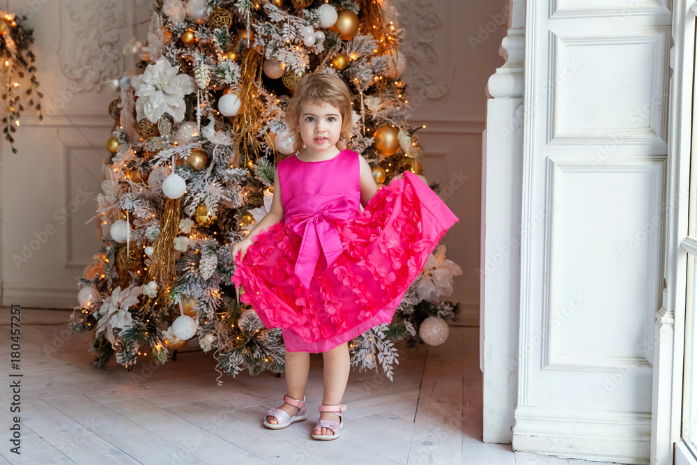 young girl near a Christmas tree
