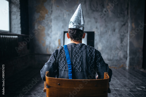 Tableau sur toile Man in tinfoil helmet watches TV, ufo phobia
