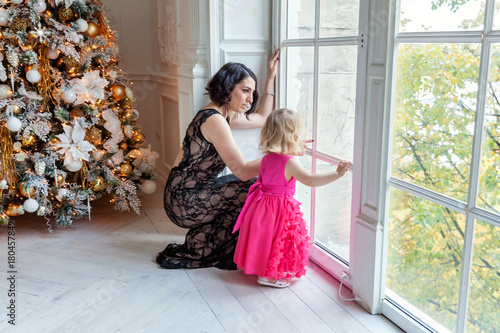 mother and daughter near a Christmas tree