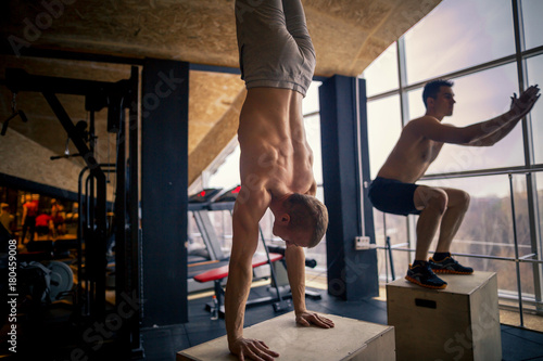 Slika na platnu Handstand push-up man workout at gym pus ups