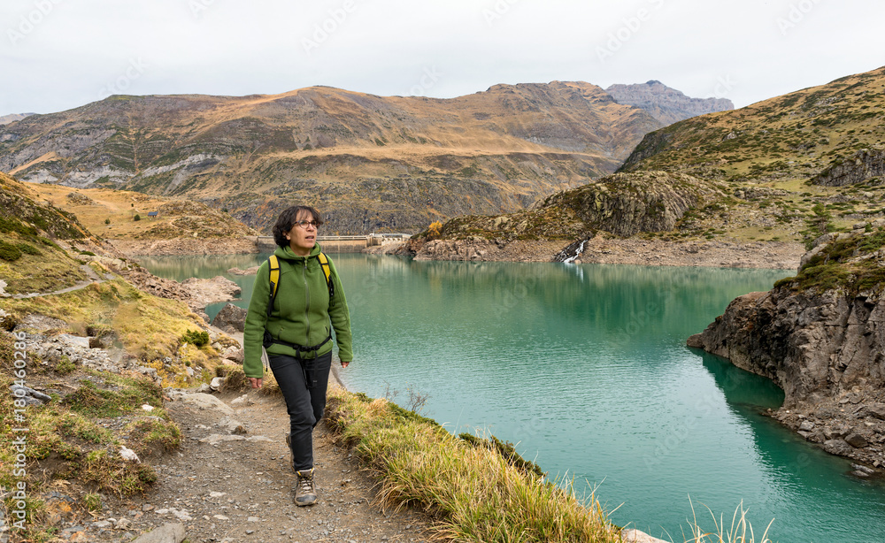 woman hiking near a mountain lake