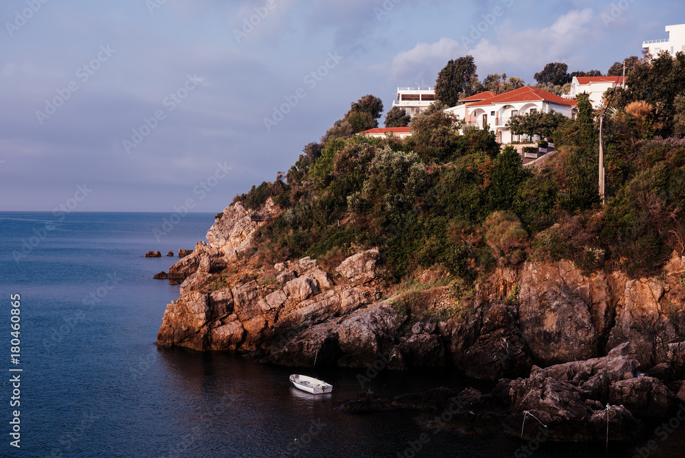 Montenegro, city of Ulcinj, the month of October, the Adriatic sea, morning, fisherman's boat off the rocky coast.