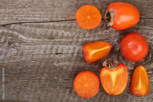 persimmon on old wooden background with copy space for your text. Top view. Flat lay pattern
