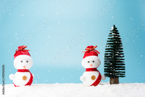 Christmas tree and snowman on snow © Worawut