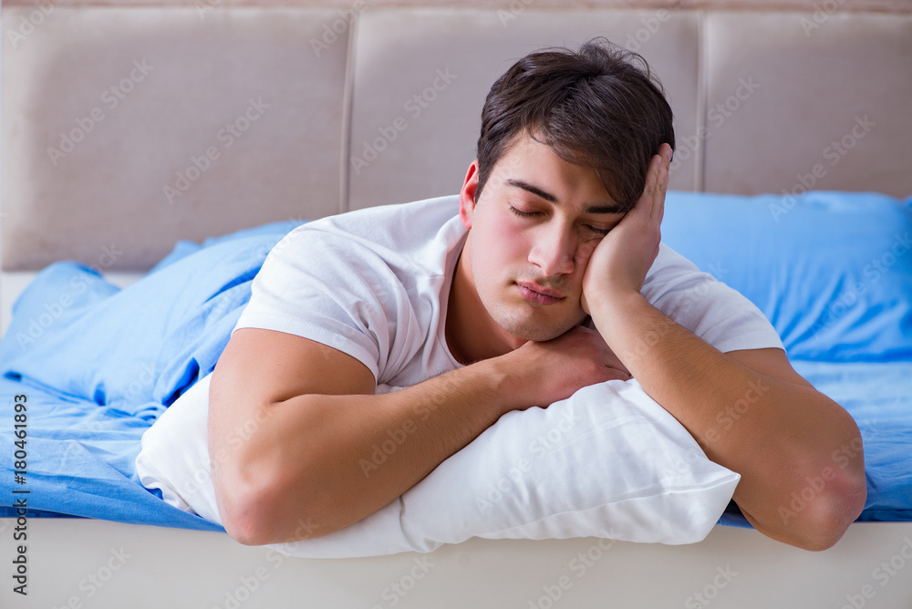 Man suffering from insomnia lying in bed Man suffering from insomnia lying in bed