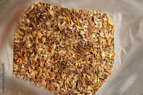 Milled barley malt inside a plastic packet. This image can be used to represent beer making. 