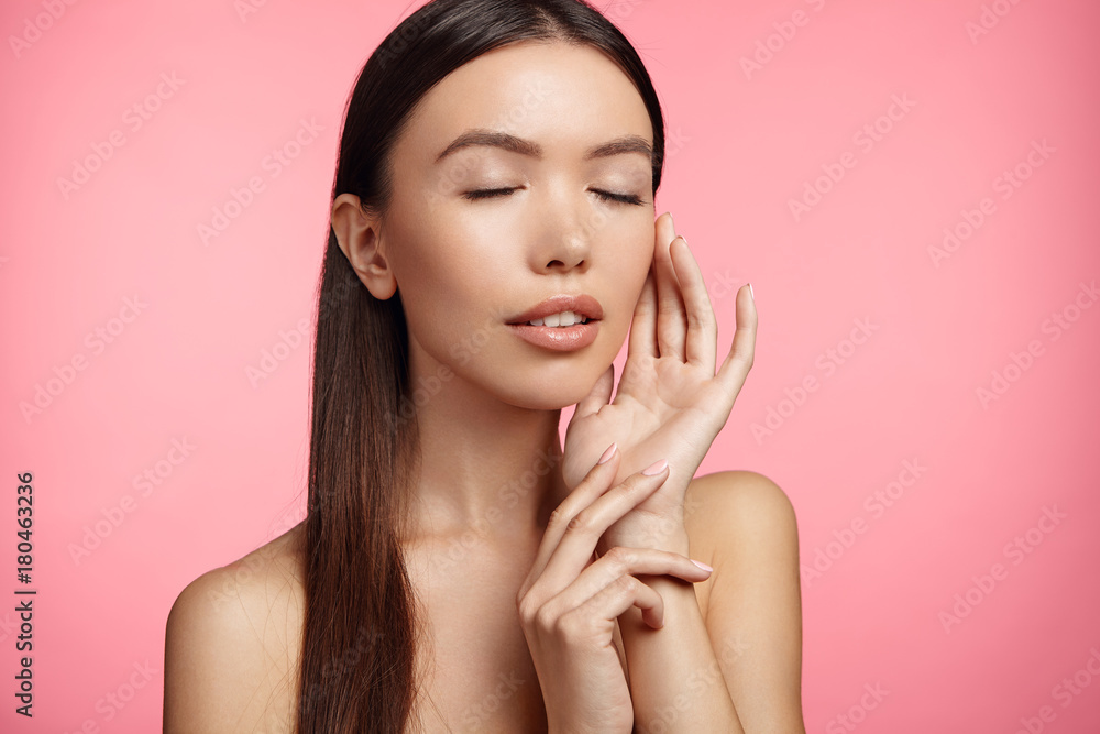 Portrait of gorgeous brunette female with tender feautures, poses topless in pink studio, advertises high quality cream and delicate skin after its effect. Beautiful spa woman with closed eyes Portrait of gorgeous brunette female with tender feautures, poses topless in pink studio, advertises high quality cream and delicate skin after its effect. Beautiful spa woman with closed eyes