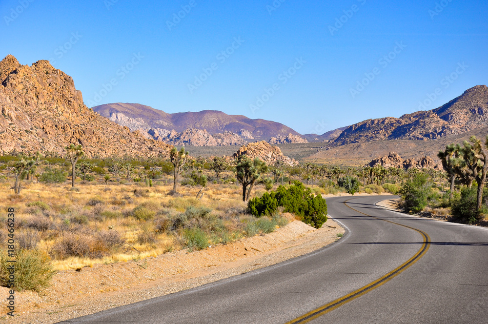Winding road in semi-desert nature and high sharp rocks Winding road in semi-desert nature and high sharp rocks
