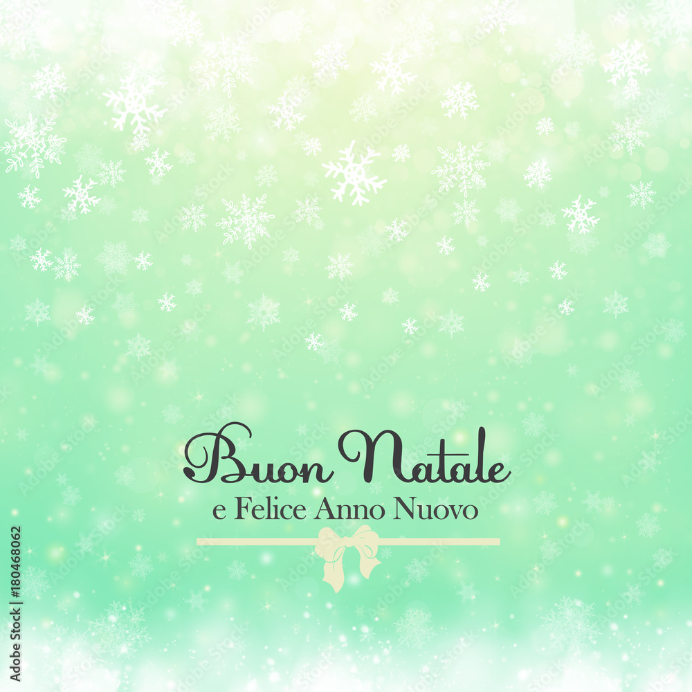 Christmas winter abstract background with snowflakes, bokeh lights and congratulations. Christmas New Year's wallpaper. Buon Natale e Felice Anno Nuovo