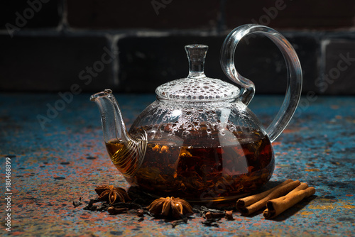 tea masala in a glass teapot on a dark background