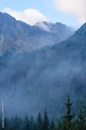mountain tops in autumn covered in mist or clouds